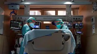 Dos médicos atienden a un paciente con coronavirus en un hospital. Dos médicos atienden a un paciente con coronavirus en un hospital
