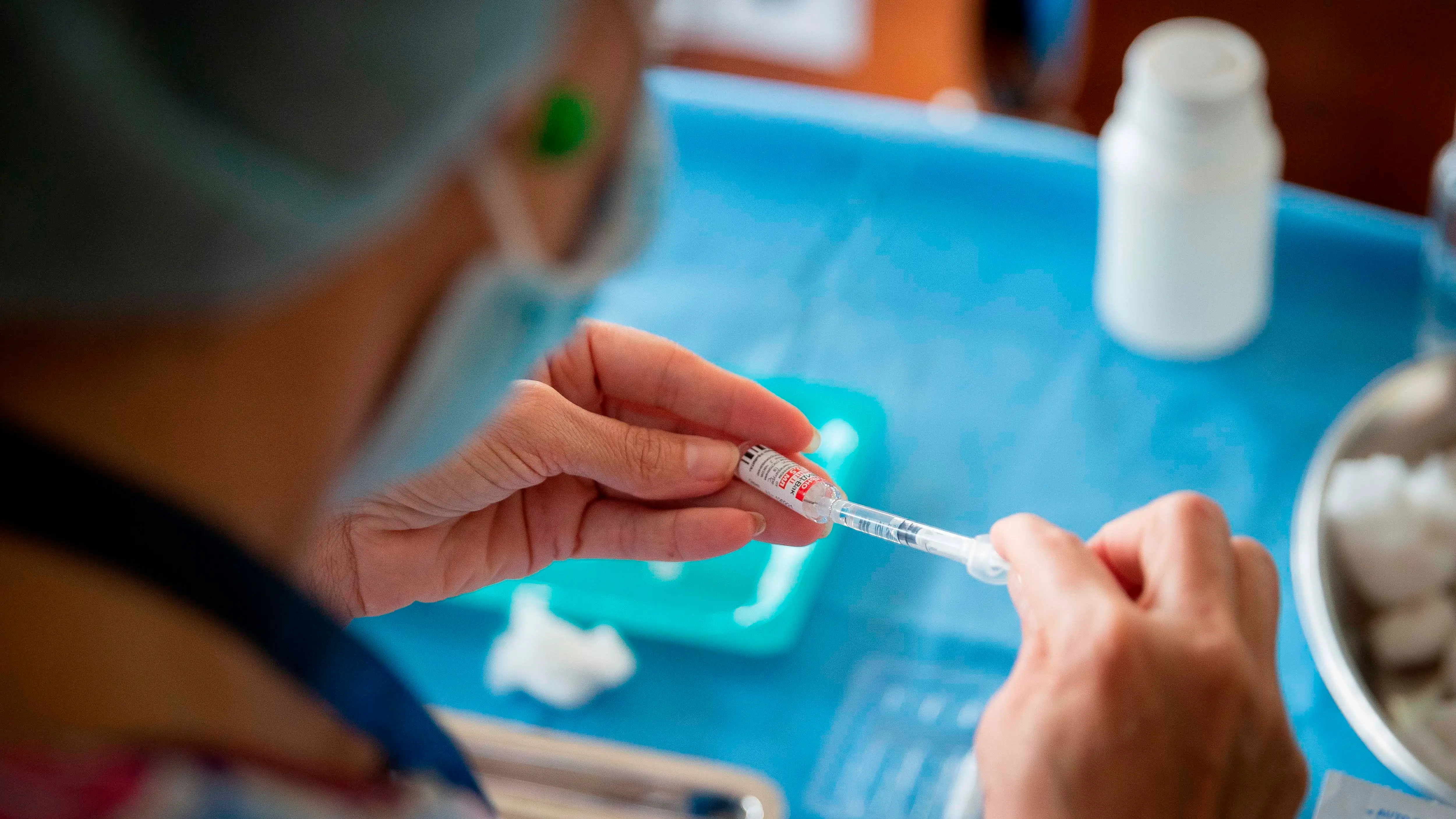 Imagen de una sanitaria manipulando una vacuna La vacuna personalizada contra el cáncer es segura y beneficiosa en pacientes con cáncer de vejiga o pulmón