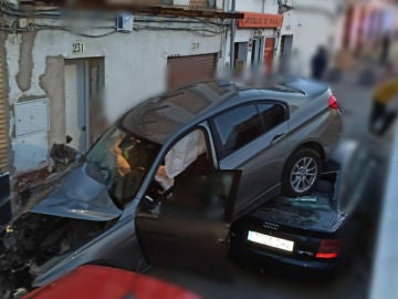 Espectacular accidente de un coche en El Viso (Andalucía) tras caer por un desnivel y quedar encima de otros turismos aparcados