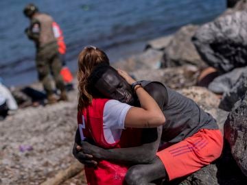 El abrazo entre un migrante y una cooperante de Cruz Roja.