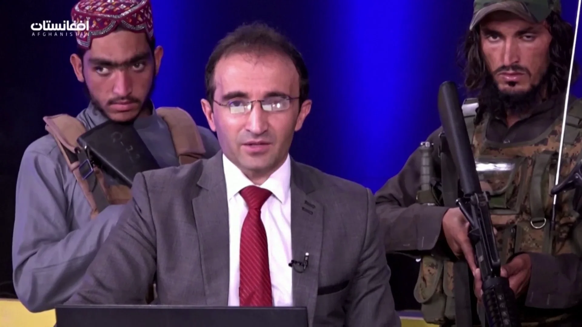 La impactante imagen de un presentador rodeado de talibanes armados que piden a la población no tener miedo La impactante imagen de un presentador rodeado de talibanes armados que piden a la población no tener miedo