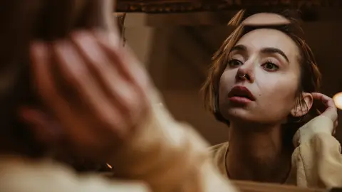 Mujer mirándose al espejo Mujer mirándose al espejo