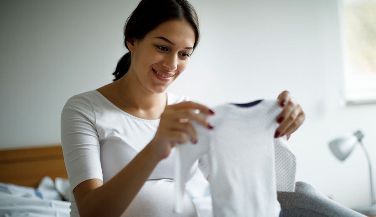 Mujer selecciona ropa de bebé