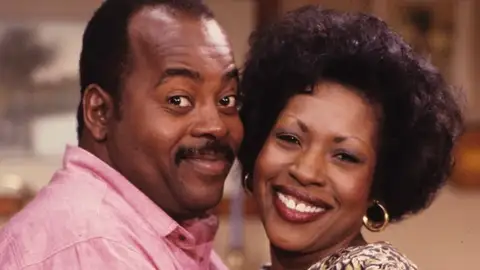 Jo Marie Payton y Reginald VelJohnson como Harriette y Carl Winslow en 'Cosas de Casa' Jo Marie Payton y Reginald VelJohnson como Harriette y Carl Winslow en 'Cosas de Casa'