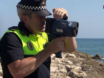 Imagen de un policía con un radar en la playa