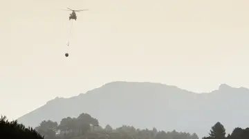 Un helicóptero se dirige cargado con agua hacia el frente del incendio forestal declarado en la Vall d'Ebo (Alicante). Un helicóptero se dirige cargado con agua hacia el frente del incendio forestal declarado en la Vall d'Ebo (Alicante).
