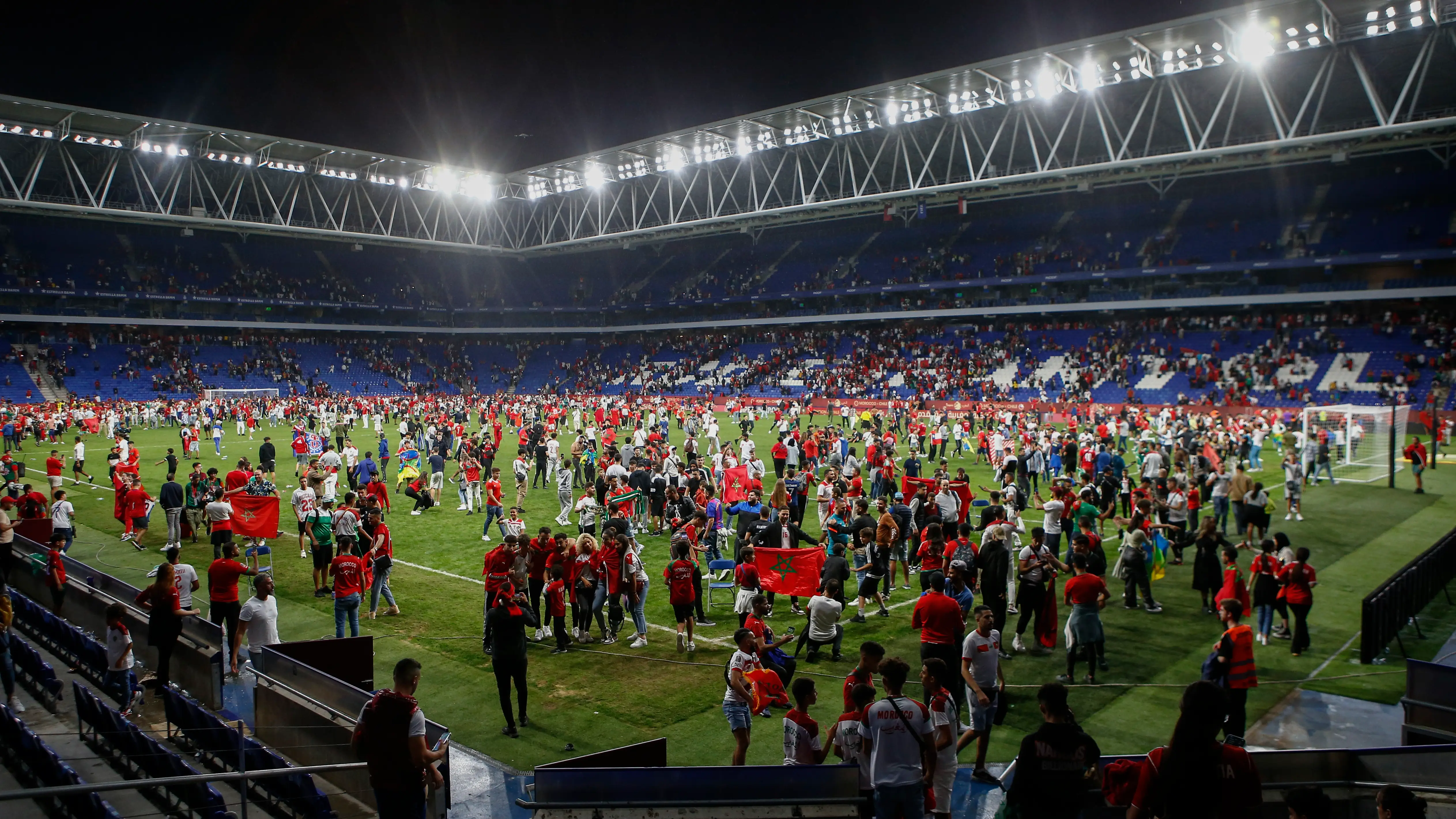 Cientos de aficionados se cuelan en el RCDE Stadium y asaltan el césped durante el Marruecos - Chile Cientos de aficionados se cuelan en el RCDE Stadium y asaltan el césped durante el Marruecos - Chile