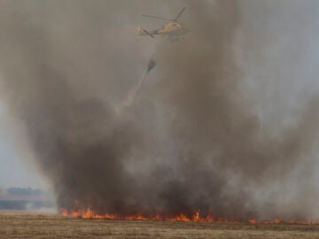 Un helicóptero trabaja en las labores de extinción del incendio forestal de la comarca de Tábara (Zamora) 