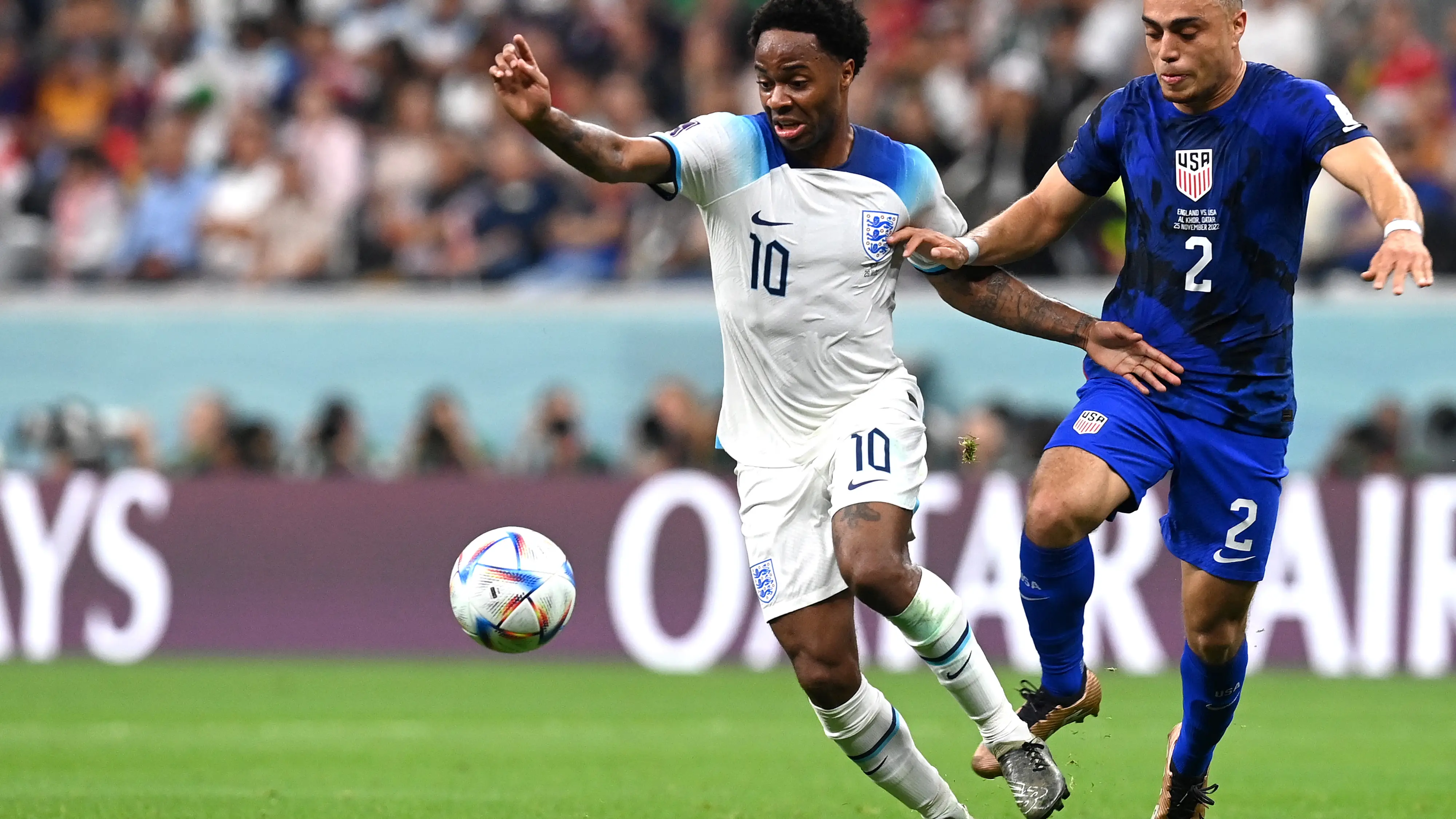 Sterling se lleva un bal&oacute;n ante Dest en el partido de fase de grupos del Mundial de Qatar