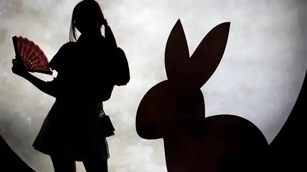 Una mujer junto a una escultura de celebración del Año Nuevo Chino 2023, año del conejo. Una mujer junto a una escultura de celebración del Año Nuevo Chino 2023, año del conejo.