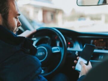 Imagen de una persona utilizando el móvil mientras conduce