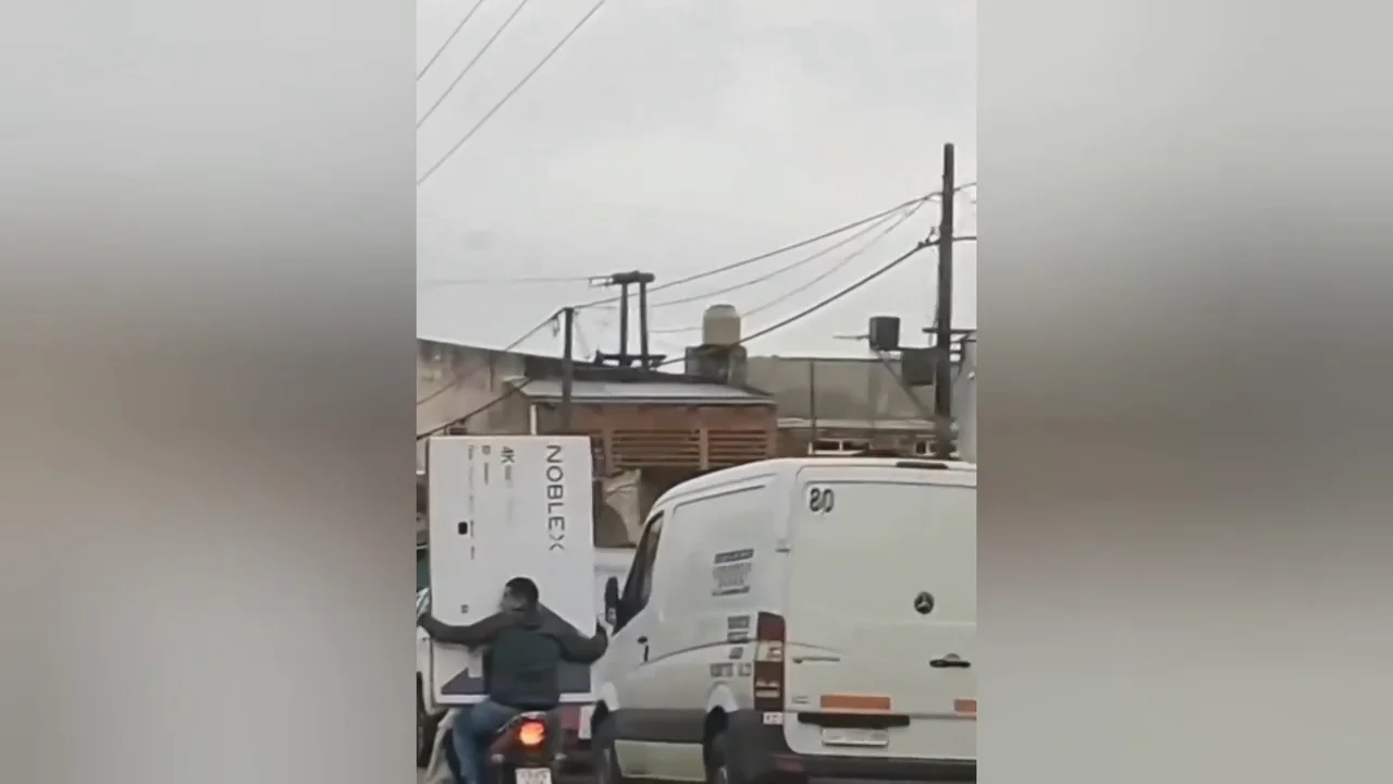 Un hombre lleva una televisi&oacute;n de 65 pulgadas en su moto
