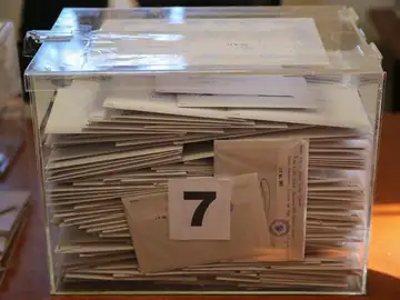 Urna electoral con los votos Urna electoral con los votos