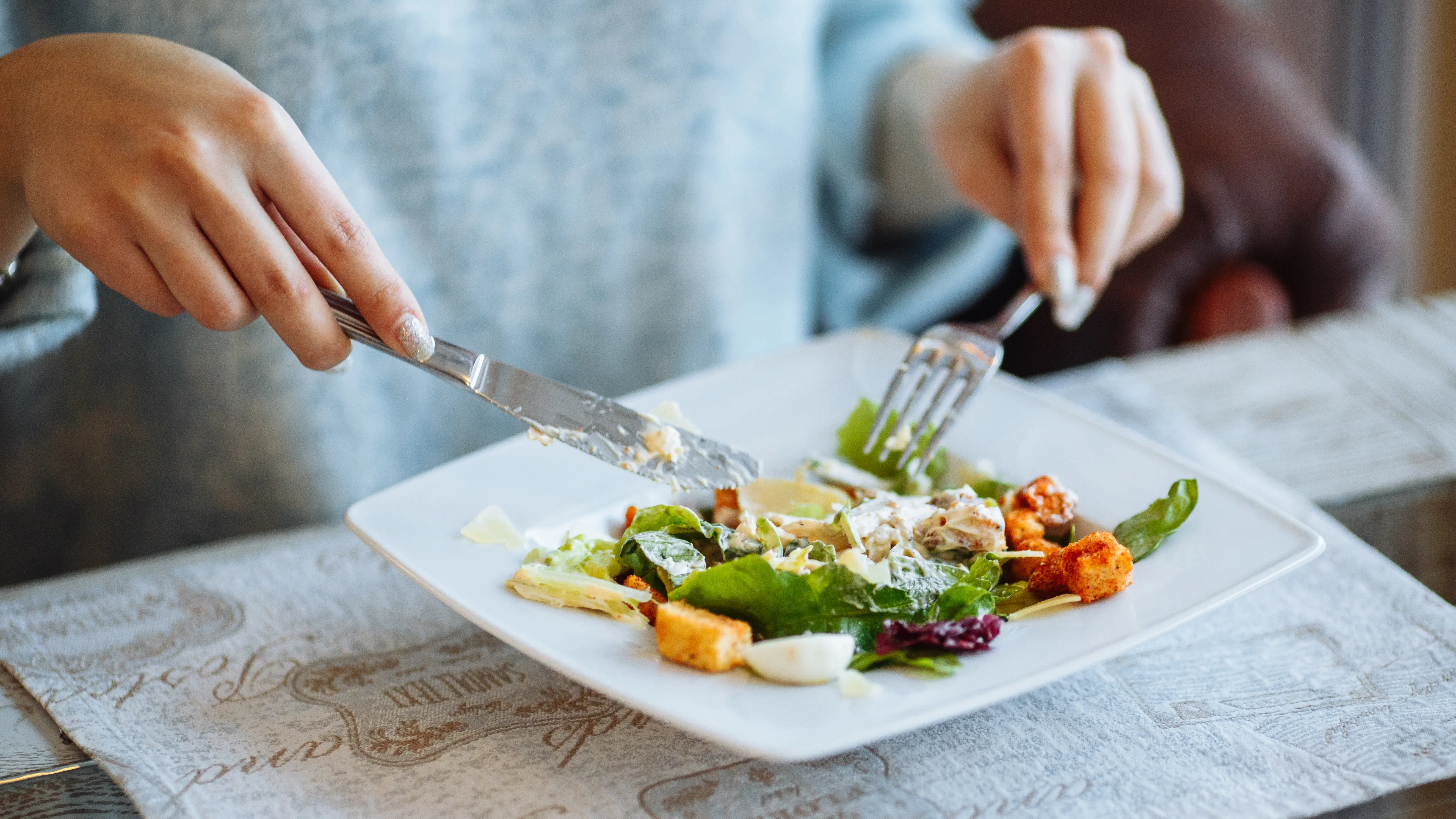 Una mujer comiendo una ensalada Una mujer comiendo una ensalada