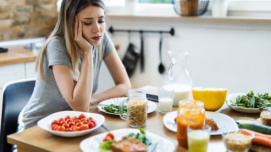 Mujer sin apetito frente a la comida