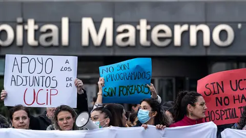 Manifestantes sujetan pancartas durante una protesta tras el cierre de la UCI pediátrica del Hospital Universitario La Paz