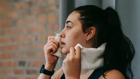 Chica se quita el sudor en el gimnasio Chica se quita el sudor en el gimnasio