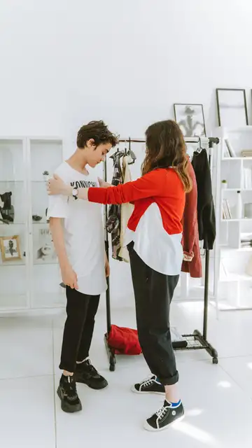 Madre vistiendo a hijo Madre vistiendo a hijo
