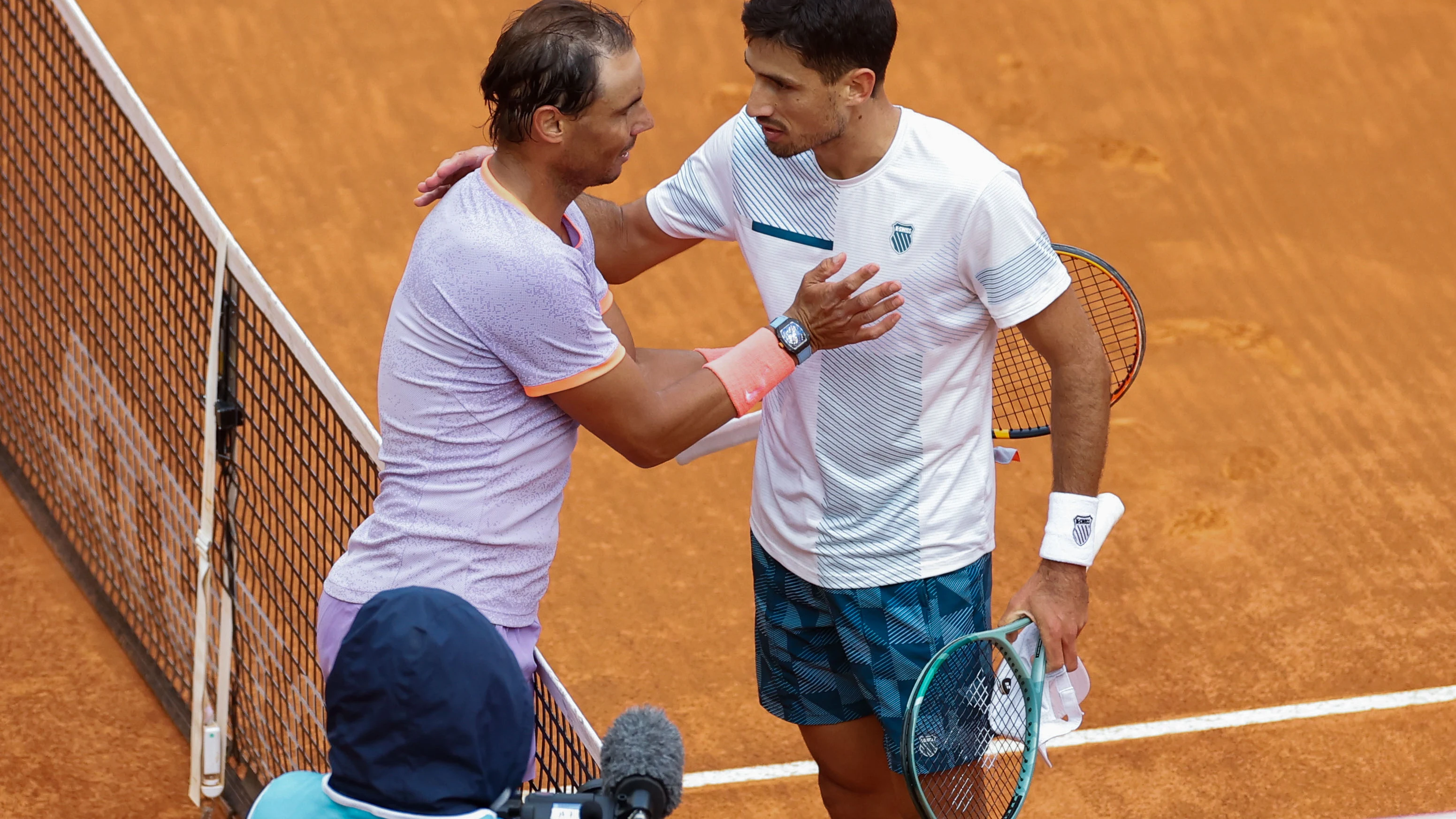 Rafa Nadal y Pedro Cach&iacute;n se saludan en la red tras el partido del Mutua Madrid Open 2024