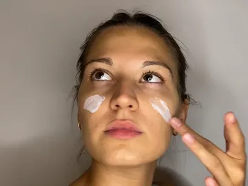 Mujer haciéndose el skincare Mujer haciéndose el skincare