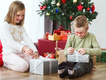 Niños en Navidad abriendo regalos