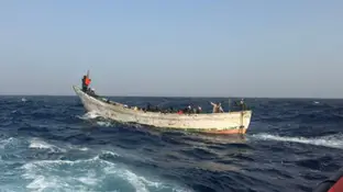 Cayuco con inmigrantes en medio del mar cerca de las Islas Canarias Cayuco con inmigrantes en medio del mar cerca de las Islas Canarias