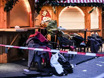 Prendas de ropa apiladas en sillas se ven detrás de un cordón policial después de un atropello en un mercadillo de Navidad en Magdeburgo Prendas de ropa apiladas en sillas se ven detrás de un cordón policial después de un atropello en un mercadillo de Navidad en Magdeburgo