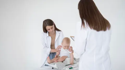 Unas pediatras con un bebé Unas pediatras con un bebé