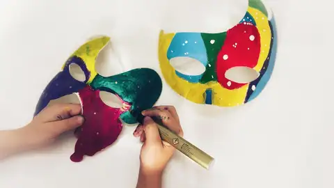 Niño pintando una máscara de Carnaval Niño pintando una máscara de Carnaval