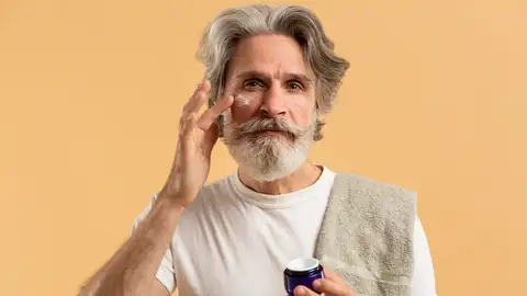 Hombre aplicándose cosméticos Hombre aplicándose cosméticos