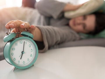 Una mujer apaga el despertador