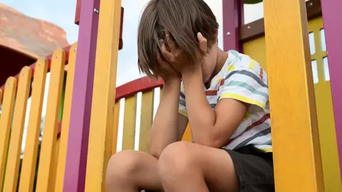 Niño triste en un parque Niño triste en un parque