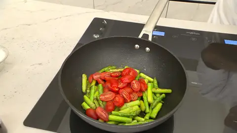 Corta los tomates por la mitad y añádelos al wok Corta los tomates por la mitad y añádelos al wok