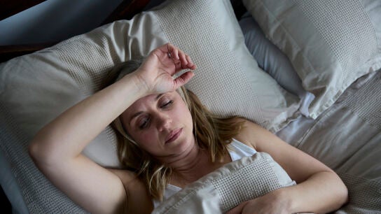 Mujer en la cama sin poder dormir