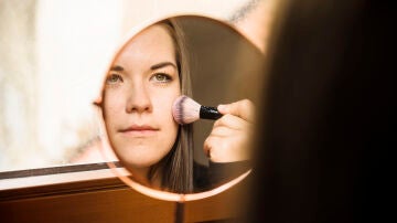 Mujer aplicándose colorete