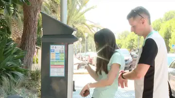 Imagen de dos chicos usando un parkímetro. Imagen de dos chicos usando un parkímetro.