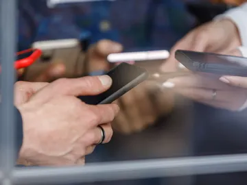 Jóvenes haciendo gestiones bancarias con el móvil Jóvenes haciendo gestiones bancarias con el móvil