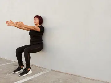 Una mujer haciendo ejercicios isométricos Una mujer haciendo ejercicios isométricos