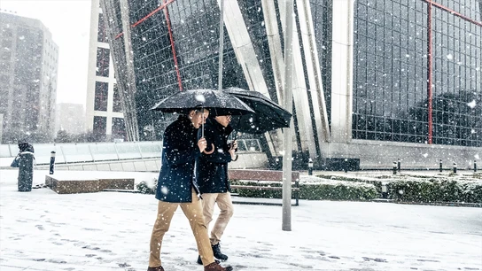 Dos hombres caminando bajo la nieve en Madrid Dos hombres caminando bajo la nieve en Madrid