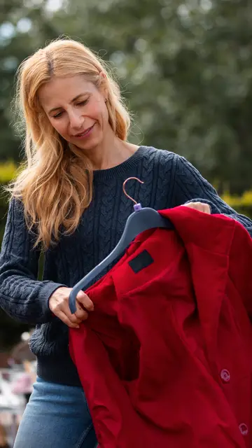 Mujer con un abrigo en una percha Mujer con un abrigo en una percha