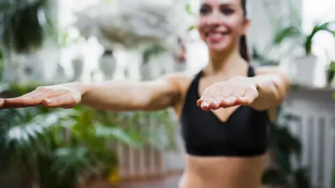 Mujer haciendo ejercicio con los brazos estirados Mujer haciendo ejercicio con los brazos estirados