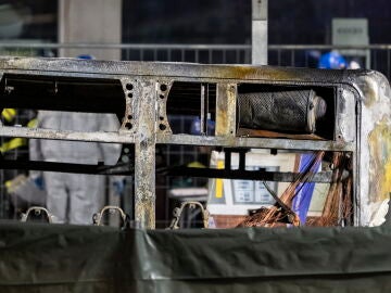 The rear of the charred shell of a postal bus stands after it caught fire in Kerzers, Switzerland, 10 March 2026