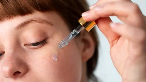 Mujer aplicándose séurm Mujer aplicándose séurm