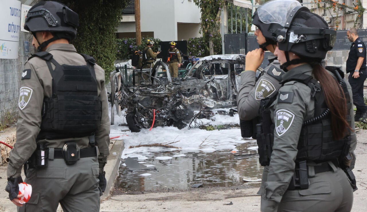 Israeli security and rescue forces work at the site of an Iranian strike in Tel Aviv