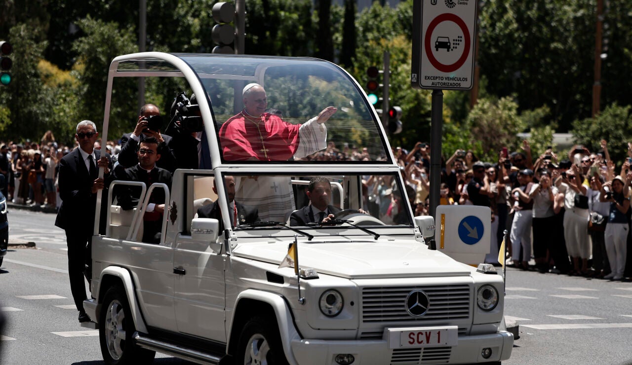El papa Le&oacute;n XIV saluda a los fieles en su recorrido por el centro de Madrid en el papam&oacute;vil, en el primer trayecto que el Sumo Pont&iacute;fice