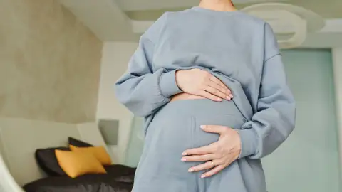 Mujer que siente su abdomen hinchado Mujer que siente su abdomen hinchado