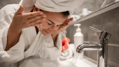 Mujer lavándose la cara Mujer lavándose la cara