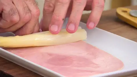 Enrolla dos espárragos en cada trozo de jamón Enrolla dos espárragos en cada trozo de jamón
