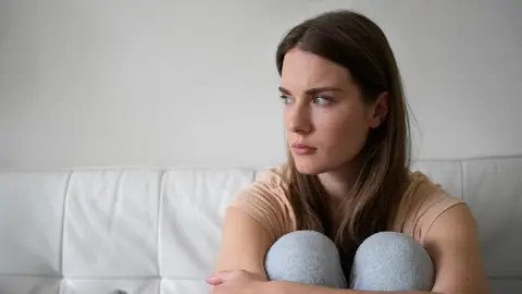 Mujer con ansiedad en el sofá Mujer con ansiedad en el sofá