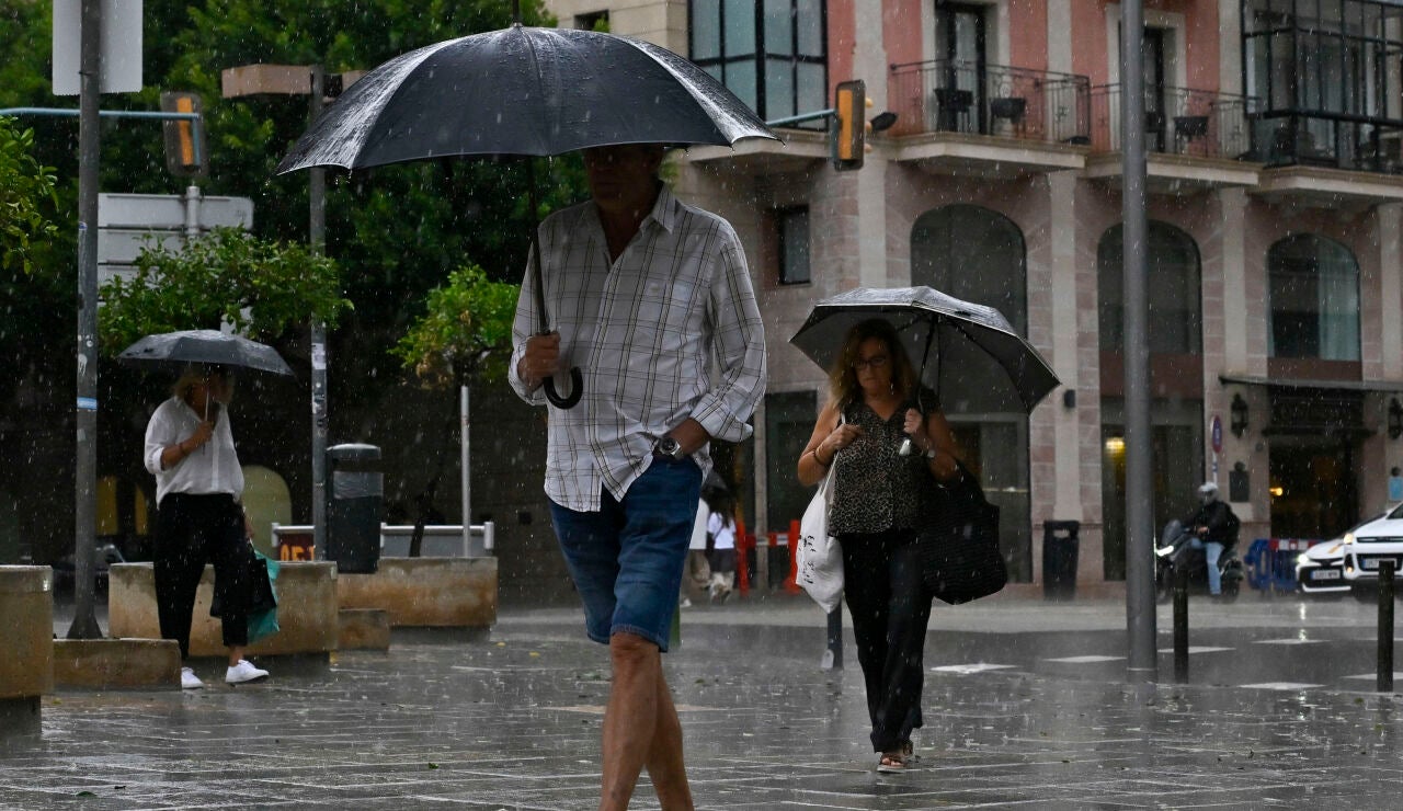 Personas protegi&eacute;ndose de la lluvia